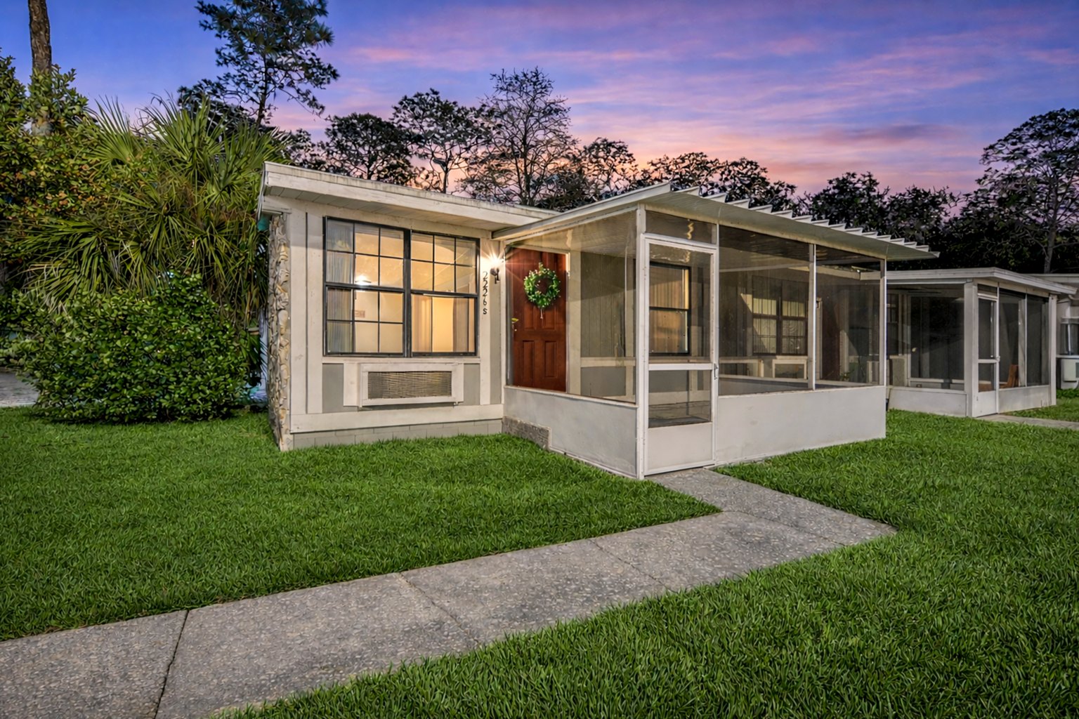Live Oak Apartments exterior and walkway in Tampa at dusk.